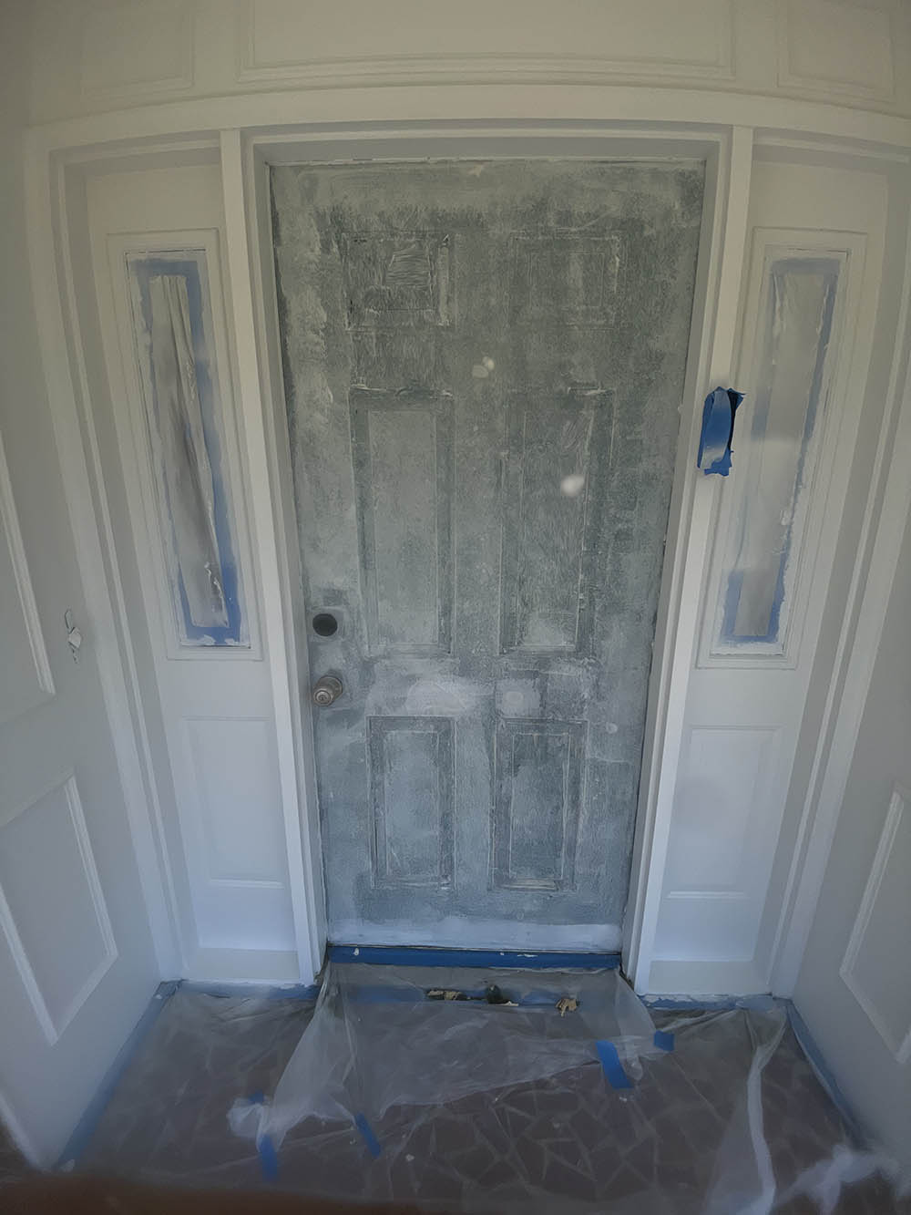Front door fully prepped, filled, masked, and primed before finish coating